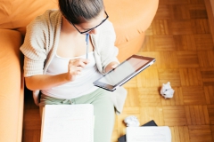 Young woman studying sitting on the floor