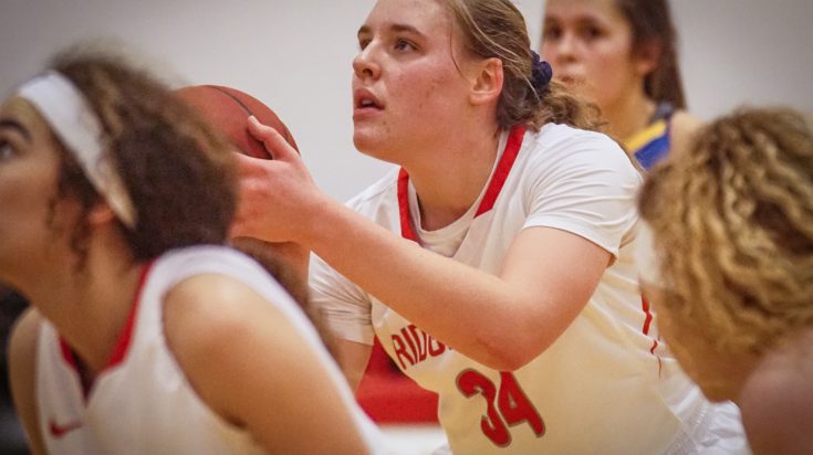 Female basketball player preparing to take her shot.