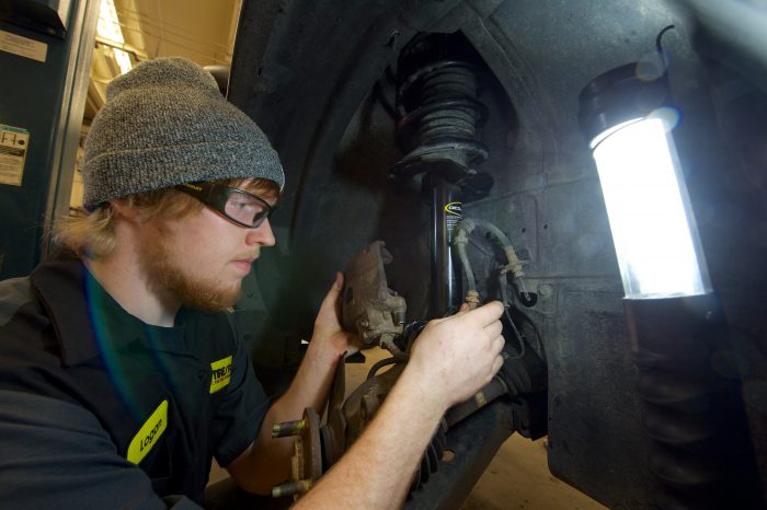 Automotive technology student working on a car