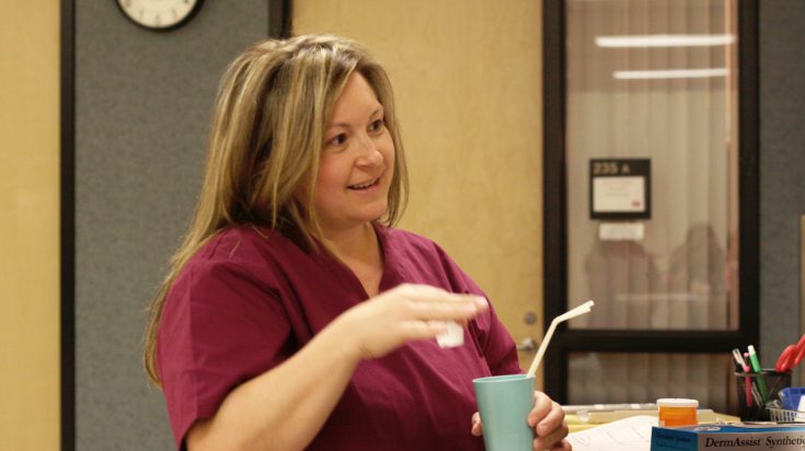 Nursing student with glass of water