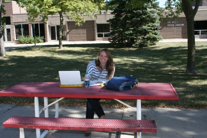 Willmar Campus Outside lady sitting at picnic table