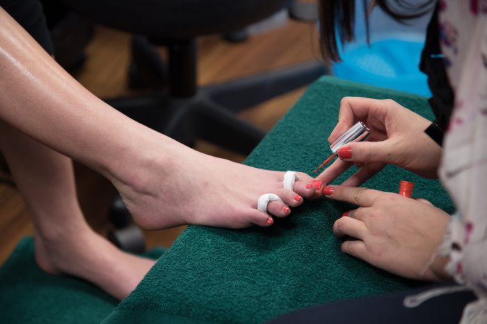 Cosmetology student giving a pedicure