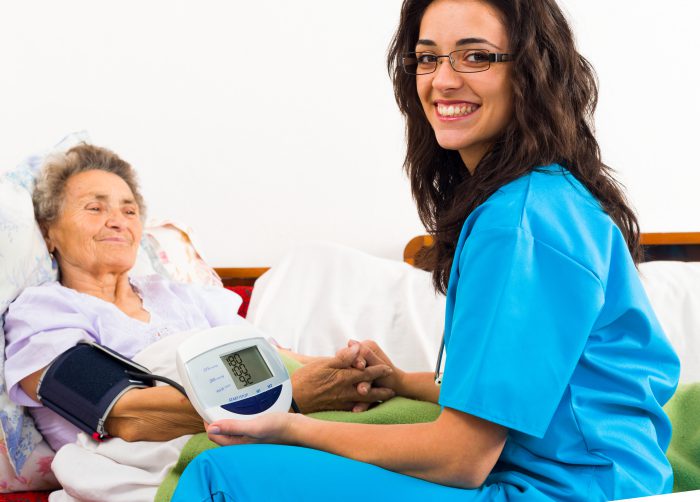 medical employee working with an elderly patient