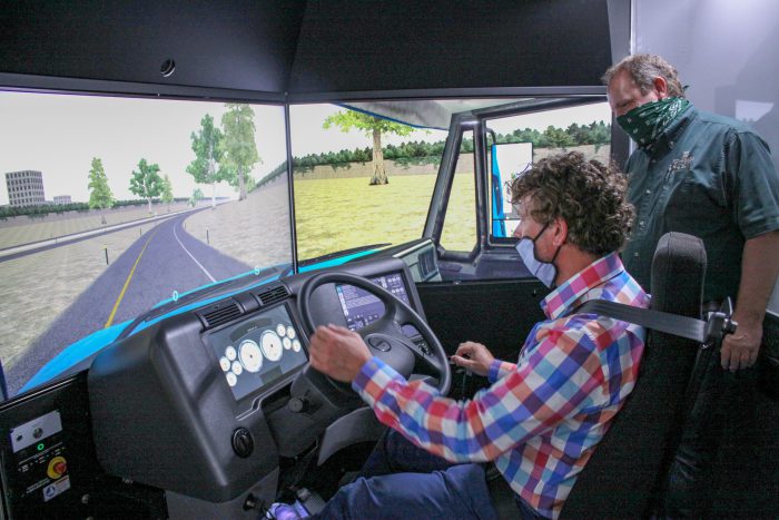 Photo of a student and an instructor on the farming simulator
