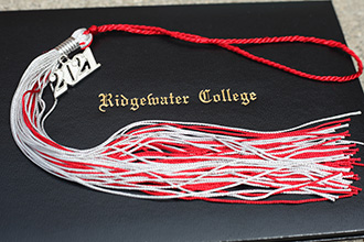 Photo of a diploma holder and a tassel