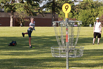 Picture of two players playing disc golf.