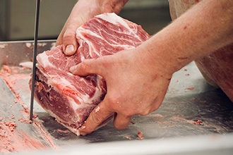Meat is cut and processed from a hog at Carlson Meat Shop in Grove City.