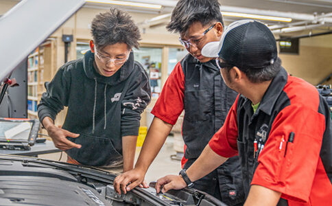 Auto body student working on a car