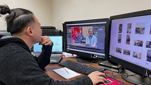 student working in Photoshop on left screen, photo files on the right screen