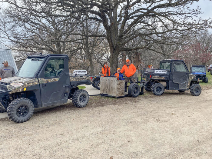 Photo of hunters and volunteers using one of the customized trailers