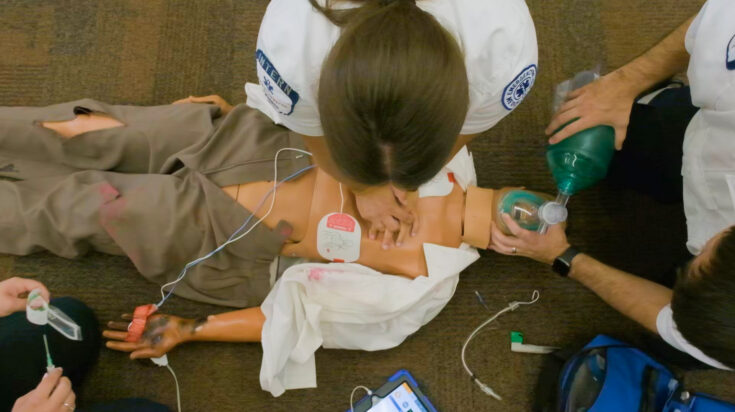 Photo of paramedic students working on patient